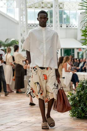 Models present creations from Adolfo Dominguez s Croma collection for spring-summer 2027 during Mercedes-Benz Fashion Week Madrid. Under the creative direction of Tiziana Domínguez, the Galician label, marking its 50th anniversary, remained faithful to its signature codes, showing pronounced asymmetry, scarves worked into both menswear and womenswear, sequins and textile appliques, alongside organic cotton denim dyed in tangerine tones and mini-pleated men s trousers. September 14,2026. (20260914831)