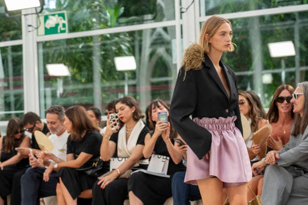 Models present creations from Adolfo Dominguez s Croma collection for spring-summer 2027 during Mercedes-Benz Fashion Week Madrid. Under the creative direction of Tiziana Domínguez, the Galician label, marking its 50th anniversary, remained faithful to its signature codes, showing pronounced asymmetry, scarves worked into both menswear and womenswear, sequins and textile appliques, alongside organic cotton denim dyed in tangerine tones and mini-pleated men s trousers. September 14,2026. (202609141008)