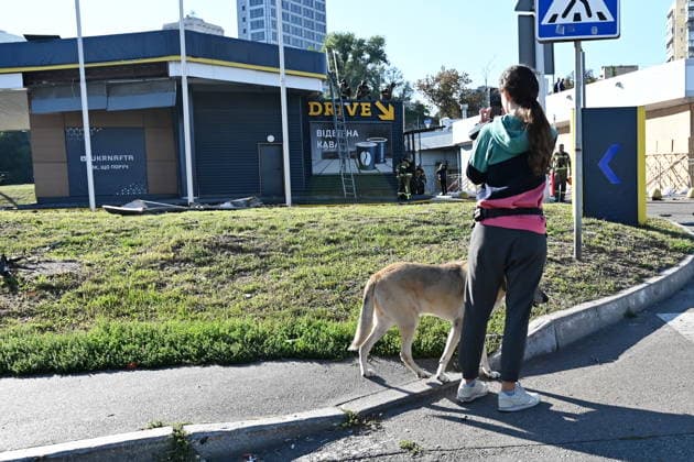 Attack On Gas Stations In Kyiv, Ukraine A young woman takes a photograph of a gas station damaged by a Russian jet-powered drone strike in the Holosiivskyi district of Kyiv, on September 15, 2026. Kyiv Ukraine  Copyright: xOleksandrxGusevx originalFilename: gusev-attackon260915_npwmF.jpg