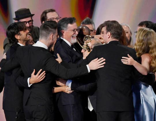 Stephen Colbert (C) holds the Emmy as crew including Ariel Dumas, Opus Moreschi, Lauren Marcello, Sara Vilkomerson, Gabriel W Gronli, Stephen Colbert, Paul Dinello, Bjoern Stejskal, Tanya Michnevich Bracco, Matt Lappin, Michael R Brumm and Aaron Cohen accept the Outstanding Variety Series Award for The Late Show with Stephen Colbert on stage during the 78th annual Primetime Emmy Awards at the Peacock Theater in Los Angeles on Monday, September 14, 2026. LAP20260914906 JIMxRUYMEN