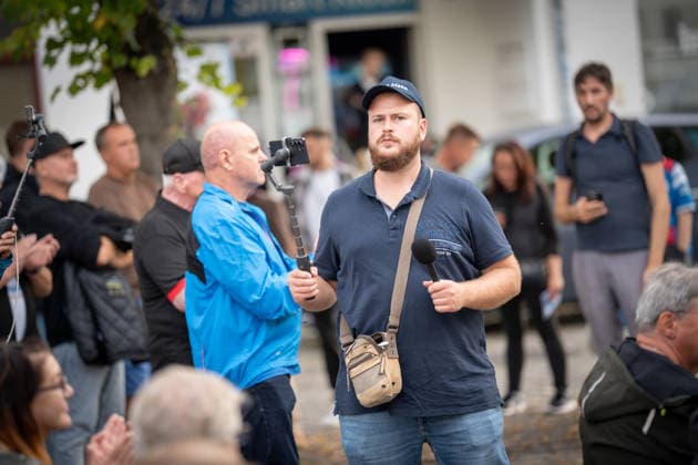 Live streamer Matthäus Westfal, known as Aktivist Mann, at the AfD campaign event—wearing a dark blue top—for the 2026 state election in Mecklenburg-Western Pomerania, Bad Doberan, Mecklenburg-Western Pomerania, Germany, Market Square