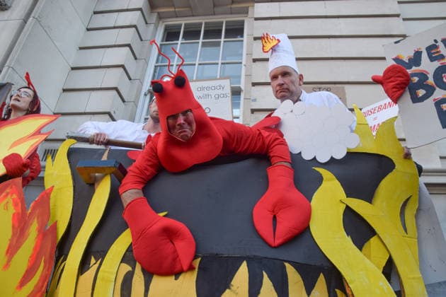 September 16, 2026, London, England, United Kingdom: Climate activists from the group Fossil Free London stage a protest outside the Department for Energy Security and Net Zero (DESNZ), with an activist dressed as a lobster cooked alive by Shell chefs . The protest is in response to the UN report that we have passed the target of 1.5 degrees celsius. The protesters are calling on the government to stop the Jackdaw gas field and Rosebank oil field in the North Sea. London United Kingdom  - ZUMAv130 20260916_zip_v130_027 Copyright: xVukxValcicx