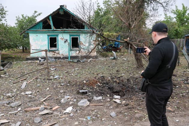 RUSSIA, DONETSK PEOPLE S REPUBLIC - SEPTEMBER 16, 2026: A man records the destruction in a house hit by a drone strike in Zolotorevka. Dmitry Yagodkin TASS  97818289
