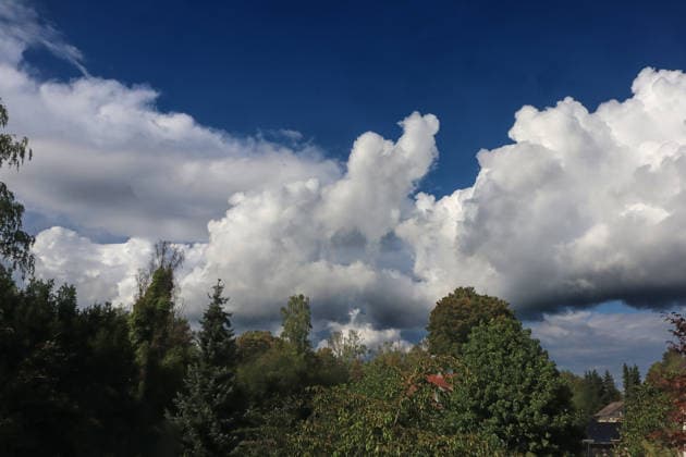 Formation of Large Cumulus Clouds: Massive cloud formations of the vertical cloud type appear in the sky in late summer, bringing scattered rain and, in some cases, thunderstorms. Essen, North Rhine-Westphalia, Germany