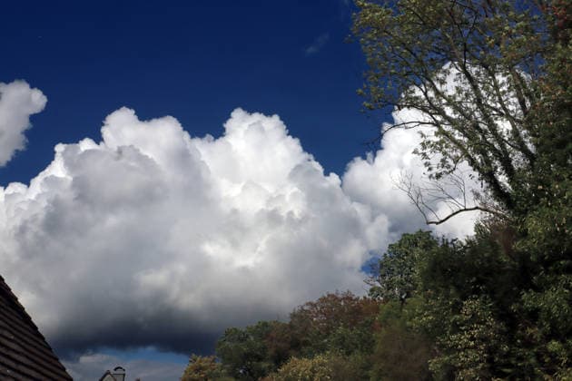 Formation of Large Cumulus Clouds: Massive cloud formations of the vertical cloud type appear in the sky in late summer, bringing scattered rain and, in some cases, thunderstorms. Essen, North Rhine-Westphalia, Germany