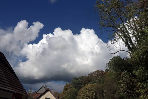 Formation of Large Cumulus Clouds: Massive cloud formations of the vertical cloud type appear in the sky in late summer, bringing scattered rain and, in some cases, thunderstorms. Essen, North Rhine-Westphalia, Germany