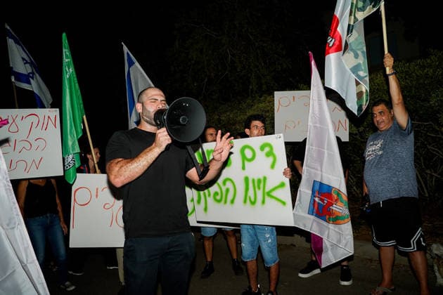Protest against the filmmakers of NAZA in Savyon, Israel - 16 SEP 2026. Right-wing activist, Ziv Baraness seen speaking through a megaphone while the other protesters seen holding placards and flags during a protest against the filmmakers of NAZA. Right-wing activists and their supporters protest outside the home of the parents of Rachel Szor, co-director of NAZA, which was awarded the Special Jury Prize at the 83rd Venice International Film Festival on September 12. The demonstration was led by right-wing activists Ziv Baraness and Mordechai David, who are involved in the election campaign of Itamar Ben Gvirís Otzma Yehudit party. Protesters criticized the filmís content, alleging that testimonies featured in it contain blatant falsehoods Copyright: xSharonxEilonx xSOPAxImagesx Sharon_Eilon-336