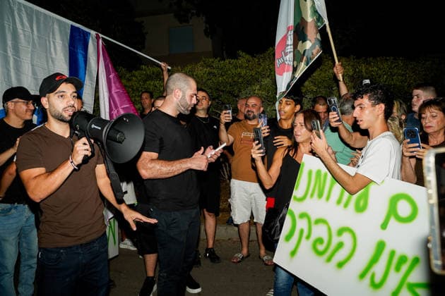 Protest against the filmmakers of NAZA in Savyon, Israel - 16 SEP 2026. Right-wing activist Mordechai David seen speaking through a megaphone while the other protesters recoding him using their phones during a protest against the filmmakers of NAZA. Right-wing activists and their supporters protest outside the home of the parents of Rachel Szor, co-director of NAZA, which was awarded the Special Jury Prize at the 83rd Venice International Film Festival on September 12. The demonstration was led by right-wing activists Ziv Baraness and Mordechai David, who are involved in the election campaign of Itamar Ben Gvirís Otzma Yehudit party. Protesters criticized the filmís content, alleging that testimonies featured in it contain blatant falsehoo Copyright: xSharonxEilonx xSOPAxImagesx Sharon_Eilon-341