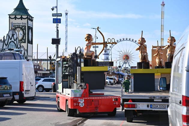 The festival grounds are bustling with activity: cars, trucks, amusement rides, carnival performers, and rides. Press tour ahead of the 191st Oktoberfest 2026 on September 17, 2026.