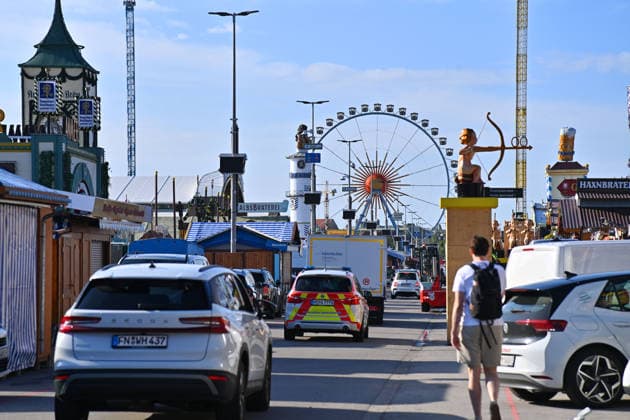 The festival grounds are bustling with activity: cars and trucks, amusement rides, carnival operators, and rides. Press tour ahead of the 191st Oktoberfest 2026 on September 17, 2026