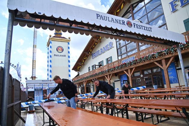 Tables and benches in the outdoor dining area of the Paulaner Festzelt are being cleaned by cleaning staff. Press tour ahead of the 191st Oktoberfest 2026 on September 17, 2026