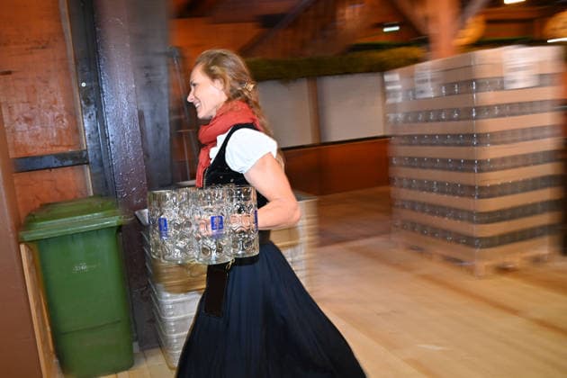Beer mugs are unpacked and placed on shelves. Female waitress, server. Press tour ahead of the 191st Oktoberfest 2026 on September 17, 2026