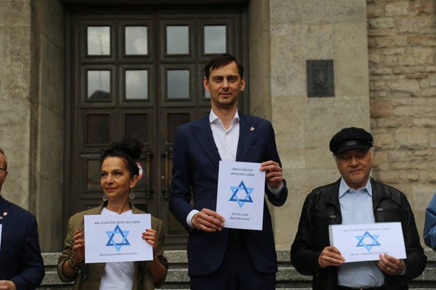 Berlin, Germany, September 17, 2026: District Mayor Martin Hikel and staff members of the Neukölln District Office participate in the Berlin Wears the Star of David campaign in front of Neukölln City Hall. Participants hold posters featuring the Star of David with the slogans We Protect Jewish Life, Against All Fo Copyright: xAlonxDavidx