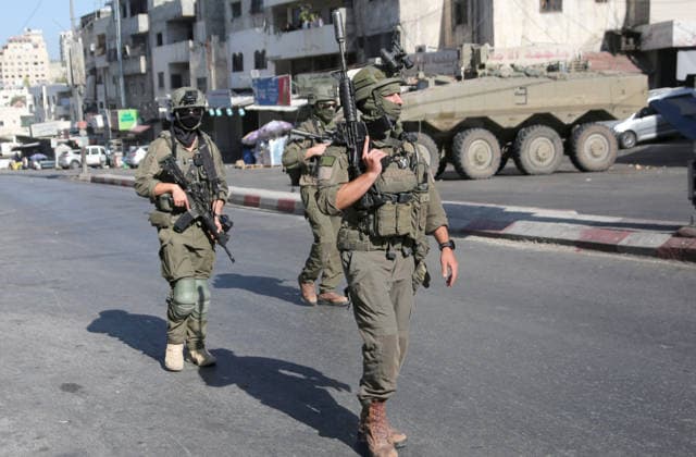 September 17, 2026, Nablus, Palestine: Israeli soldiers take positions near armored Israeli military vehicles blocking the main road at the entrance to the Al-Ain refugee camp, west of Nablus in the West Bank, during an Israeli military operation to search for combat materials. Residents reported that the army raided and searched homes and arrested five people, and some people were injured after being severely beaten. Nablus Palestine  - ZUMAs197 20260917_aaa_s197_035 Copyright: xNasserxishatyehx