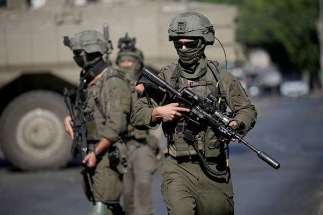 September 17, 2026, Nablus, Palestine: Israeli soldiers take positions near armored Israeli military vehicles blocking the main road at the entrance to the Al-Ain refugee camp, west of Nablus in the West Bank, during an Israeli military operation to search for combat materials. Residents reported that the army raided and searched homes and arrested five people, and some people were injured after being severely beaten. Nablus Palestine - ZUMAs197 20260917_aaa_s197_038 Copyright: xNasserxishatyehx