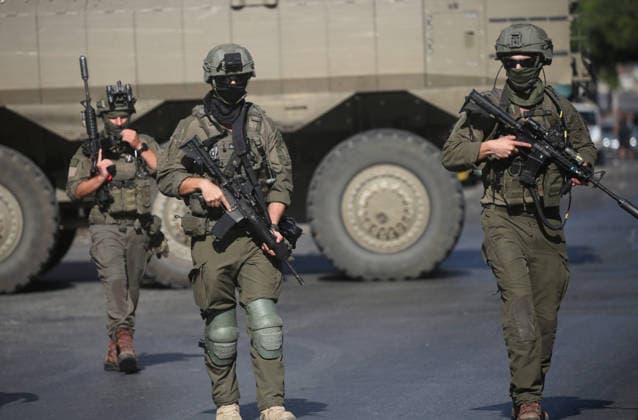 September 17, 2026, Nablus, Palestine: Israeli soldiers take positions near armored Israeli military vehicles blocking the main road at the entrance to the Al-Ain refugee camp, west of Nablus in the West Bank, during an Israeli military operation to search for combat materials. Residents reported that the army raided and searched homes and arrested five people, and some people were injured after being severely beaten. Nablus Palestine - ZUMAs197 20260917_aaa_s197_045 Copyright: xNasserxishatyehx