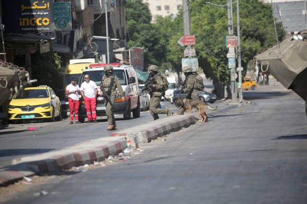 September 17, 2026, Nablus, Palestine: Israeli soldiers lead a police dog during an Israeli military operation targeting residents of the Al-Ain refugee camp, west of Nablus in the West Bank, to search for combat materials. Residents reported that the army raided and searched homes and arrested five people, and some people were injured after being severely beaten. Nablus Palestine - ZUMAs197 20260917_aaa_s197_046 Copyright: xNasserxishatyehx