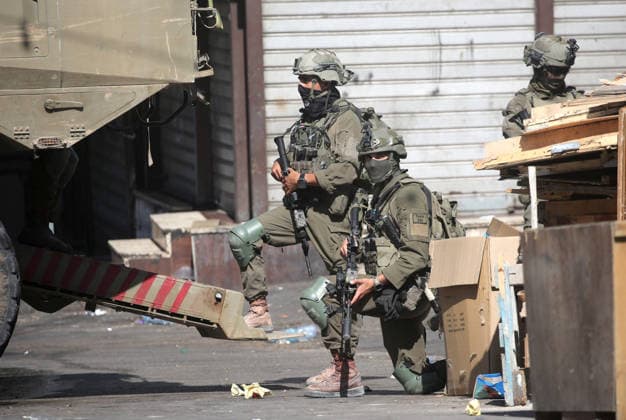 September 17, 2026, Nablus, Palestine: Israeli soldiers take positions near armored Israeli military vehicles blocking the main road at the entrance to the Al-Ain refugee camp, west of Nablus in the West Bank, during an Israeli military operation to search for combat materials. Residents reported that the army raided and searched homes and arrested five people, and some people were injured after being severely beaten. Nablus Palestine  - ZUMAs197 20260917_aaa_s197_057 Copyright: xNasserxishatyehx