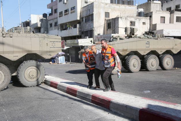 September 17, 2026, Nablus, Palestine: Palestinian paramedics transport a patient near armored Israeli military vehicles blocking the main road at the entrance to the Ein refugee camp, west of Nablus in the West Bank, during an Israeli military operation to search for weapons. Residents reported that the army raided and searched homes and arrested five people, and some people were injured after being severely beaten. Nablus Palestine  - ZUMAs197 20260917_aaa_s197_062 Copyright: xNasserxishatyehx