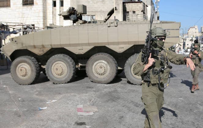September 17, 2026, Nablus, Palestine: An Israeli soldier takes position near armored Israeli military vehicle blocking the main road at the entrance to the Al-Ain refugee camp, west of Nablus in the West Bank, during an Israeli military operation to search for combat materials. Residents reported that the army raided and searched homes and arrested five people, and some people were injured after being severely beaten. Nablus Palestine - ZUMAs197 20260917_aaa_s197_061 Copyright: xNasserxishatyehx