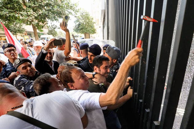 September 17, 2026, Beirut, Beirut, Lebanon: Former Lebanese minister Issam Charafeddine uses a hammer to knock the glass of a local bank in Beirut during a protest by depositors who are still unable to withdraw their foreign-currency savings. Depositors called on the government and Parliament to adopt a fair plan to recover their funds. Demonstrators clashed with security forces guarding a bank leaving several people injured among the protesters. Beirut Lebanon  - ZUMAn313 20260917_zip_n313_001 Copyright: xMarwanxNaamanix