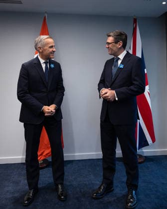 Prime Minister Mark Carney ( L) with British Prime Minister Andy Burnham at Hill Dickinson Stadium in Liverpool, England, on Wednesday, Sept. 16, 2026.  FRN2026091722 CanadianxPresidency