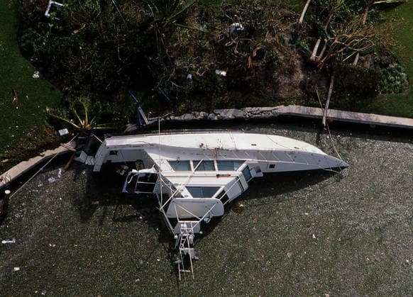 August 24, 1992 - Miami, Florida, U.S. - A boat overturned from Hurricane Andrew is seen in the Intracoastal waterway on August 24, 1992, near Miami Florida. The category 5 hurricane became the most destructive hurricane to ever hit Florida in terms of structures damaged or destroyed and was the costliest in financial terms when it landed. Hurricane Andrew killed 44 and left a then-record $25 billion in damage. Las Vegas USA - ZUMAbk3_ 19920824_zaf_bk3_022 Copyright: xDavidxBeckerx