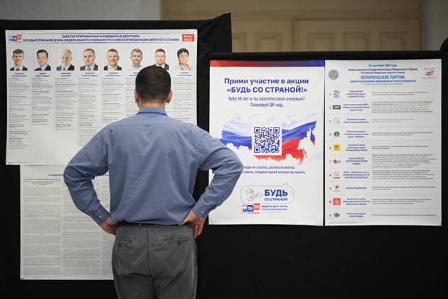 Russia Regions Parliamentary Election 9245507 18.09.2026 A man stands near at a board with information about candidates at a polling station during elections to Russia s ninth State Duma, the lower house of parliament, in Novosibirsk, Russia. Alexandr Kryazhev Sputnik Novosibirsk Russia  Copyright: xAlexandrxKryazhevx