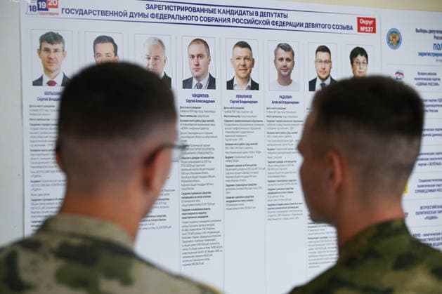 Russia Regions Parliamentary Election 9245502 18.09.2026 Men stand near at a board with information about candidates at a polling station during elections to Russia s ninth State Duma, the lower house of parliament, in Novosibirsk, Russia. Alexandr Kryazhev Sputnik Novosibirsk Russia  Copyright: xAlexandrxKryazhevx