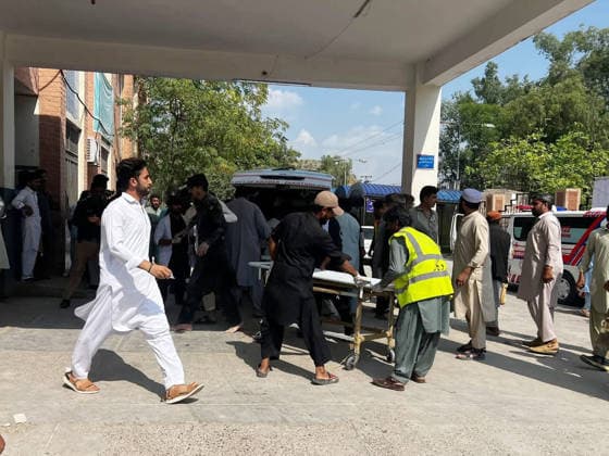 (260918) -- KOHAT, Sept. 18, 2026 -- This photo taken with mobile phone shows rescuers transferring injured people to the hospital at Kohat in Pakistan s Khyber Pakhtunkhwa province on Sept. 18, 2026. At least 16 people were killed and over 50 others injured in a twin suicide attack inside a residential compound of police in Pakistan s Khyber Pakhtunkhwa province on Friday, police and rescue officials said. (Str Xinhua) (SpotNews) PAKISTAN-KOHAT-BLAST-DEATH TOLL AhmadxKamal 