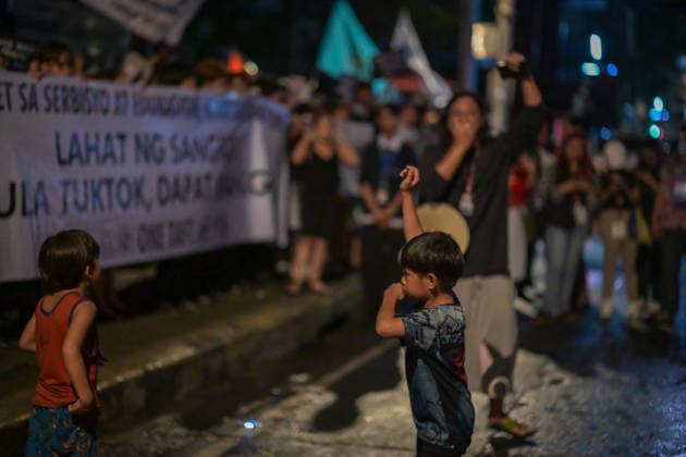 September 18, 2026, Philippines: A kid imitating the lifting of the fist by the speaker during the Black Friday Protest on Friday at Taft Ave, Metro Manila. It coincided with the Black Friday Protests from different universities and a preparation for the mass movement on Sept. 21 for the Martial Law anniversary. Among the calls were for the alleged human rights abuses, corruption, and the Pax Silica initiative under the administration of President Ferdinand Marcos Jr. Philippines  - ZUMAr240 20260918_zip_r240_003 Copyright: xMarcxDominicxRostratax