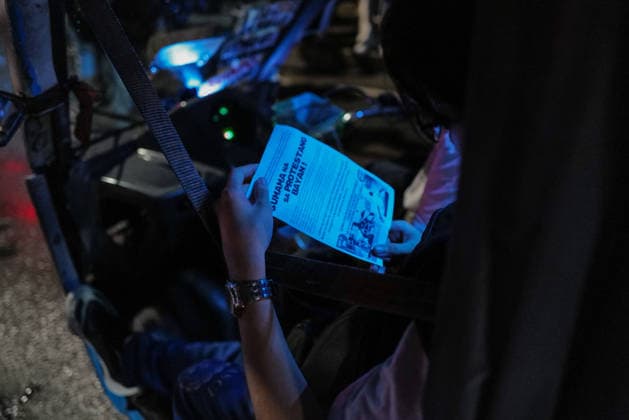 September 18, 2026, Philippines: A driver reads the pamphlet given by the students during the Black Friday Protest on Friday at Taft Ave, Metro Manila. It coincided with the Black Friday Protests from different universities and a preparation for the mass movement on Sept. 21 for the Martial Law anniversary. Among the calls were for the alleged human rights abuses, corruption, and the Pax Silica initiative under the administration of President Ferdinand Marcos Jr. Philippines - ZUMAr240 20260918_zip_r240_049 Copyright: xMarcxDominicxRostratax