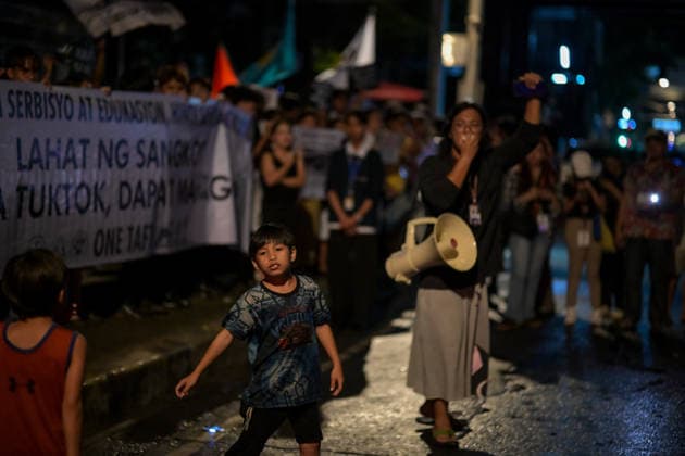 September 18, 2026, Philippines: Two kids curious about the event of Black Friday Protest on Friday at Taft Ave, Metro Manila. It coincided with the Black Friday Protests from different universities and a preparation for the mass movement on Sept. 21 for the Martial Law anniversary. Among the calls were for the alleged human rights abuses, corruption, and the Pax Silica initiative under the administration of President Ferdinand Marcos Jr. Philippines - ZUMAr240 20260918_zip_r240_012 Copyright: xMarcxDominicxRostratax
