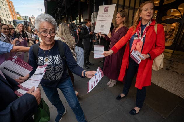 September 18, 2026, London, United Kingdom: Protesters hand out leaflets during a demonstration outside the main entrance to the Harrods department store in Knightsbridge. Survivors of alleged sexual abuse by former Harrods owner Mohamed Al Fayed and their supporters hold a demonstration outside Harrods department store in Knightsbridge, London. Protesters held placards, handed leaflets to members of the public and stood behind a large campaign banner outside the store entrance. The survivors are calling for the findings of a previous inquiry into allegations against Al Fayed to be made public and for a further public inquiry to examine the allegations and establish the truth surrounding the claims. London United Kingdom  - ZUMAs197 20260918_aaa_s197_027 Copyright: xJamesxWilloughbyx