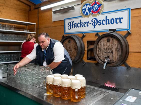(260919) -- MUNICH, Sept. 19, 2026 -- A staff member prepares cups of beer at the Oktoberfest in Munich, Germany, Sept. 19, 2026. The 191st Oktoberfest, one of the largest folk festivals in Germany, opened on Saturday in Munich, with mayor Dominik Krause tapping the first barrel of beer as a tradition. This year s festival will last until Oct. 4. ) GERMANY-MUNICH-OKTOBERFEST-OPENING ZhangxHaofu 