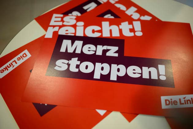 Feature, Stop Merz—Enough Is Enough poster, September 19, 2026; The Left NRW State Party Convention, September 19–20, 2026, in Mülheim an der Ruhr, Germany, Stadthalle
