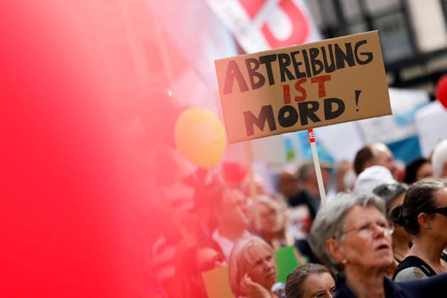 Protesters at the fourth March for Life in Cologne. A protester holds a sign reading Abortion is murder. The March for Life is a demonstration organized by the pro-life movement. It is organized by the Federal Association for the Right to Life. Protesters are demonstrating against abortions Copyright: xChristophxHardtx