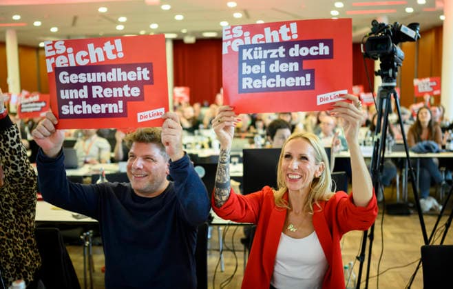 From left to right: Sebastian Merkens, state executive director and lead candidate, and Alexandra Mehdi, lead candidate for the 2027 North Rhine-Westphalia state election, hold up posters reading Secure Health Care and Pensions—Cut Taxes for the Rich, Enough is enough, on September 19, 2026, at The Left NRW State Party Convention, held from September 19 to September 20, 20