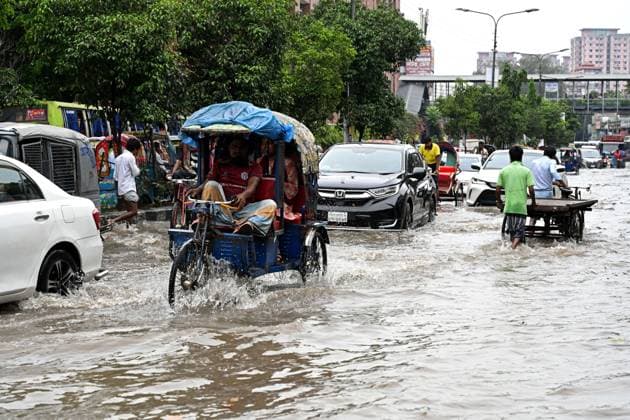 September 20, 2026, Dhaka, Bangladesh: DHAKA, BANGLADESH, SEPTEMBER 20, 2026: Vehicles and passengers navigate waterlogged streets in Dhaka following heavy rainfall in the Bangladeshi capital. Floodwater submerged sections of roads across the city, disrupting traffic and making travel difficult for residents and commuters. Dhaka Bangladesh - ZUMAq101 20260920_zna_q101_065 Copyright: xMamunurxRashidx