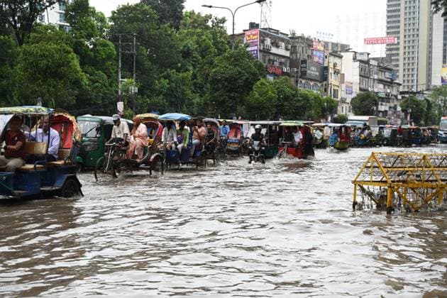 September 20, 2026, Dhaka, Bangladesh: DHAKA, BANGLADESH, SEPTEMBER 20, 2026: Vehicles and passengers navigate waterlogged streets in Dhaka following heavy rainfall in the Bangladeshi capital. Floodwater submerged sections of roads across the city, disrupting traffic and making travel difficult for residents and commuters. Dhaka Bangladesh - ZUMAq101 20260920_zna_q101_069 Copyright: xMamunurxRashidx