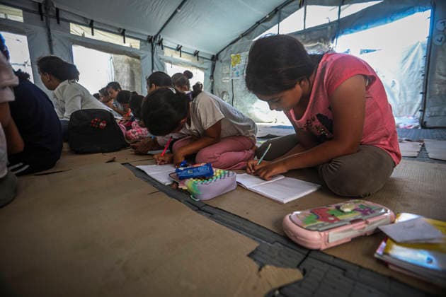 Gaza Temporary Tent Classrooms Palestinian children write during a lesson inside a temporary classroom tent in western Gaza City, Gaza Strip on September 20, 2026. Thousands of Palestinian children in the Gaza Strip have resumed lessons in temporary classrooms as the education system continues to face widespread disruption and damage following the war. Temporary learning spaces, including tents, are being used as schools and educational facilities remain damaged or unavailable. Gaza Gaza Strip Palestinian Territories Copyright: xFaizxQreqax