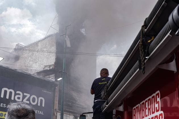 September 20, 2026, Caracas, Venezuela (Bolivarian Republic of: CARACAS, VENEZUELA, SEPTEMBER 20, 2026: Firefighters work at the scene of a fire that damaged a three-story commercial building housing the Meiliwang textile and footwear store on Avenida Principal de El Cementerio in CaracasÃ¢â‚¬â ¢ Libertador municipality. Caracas firefighters, Civil Protection teams, UCV firefighters and municipal emergency personnel responded to extinguish the blaze and carry out cooling operations. No injuries were reported, while authorities are investigating the cause of the fire. Caracas Venezuela (Bolivarian Republic of - ZUMAq101 20260920_zna_q101_189 Copyright: xMarioxFloresx