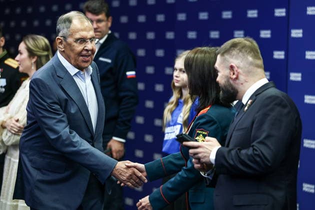 RUSSIA, MOSCOW - SEPTEMBER 20, 2026: Russia’s Minister of Foreign Affairs Sergei Lavrov, Hero of Russia, nurse Lyudmila Bolilaya and VGTRK war correspondent Yevgeny Poddubny (L-R) shake hands at the United Russia Party s Central Executive Committee office during a meeting to discuss preliminary results of the 2026 Russian State Duma election. During the 2026 Single Voting Day, which lasted from 18 to 20 September, Russian citizens went to the polls to elect members of the Russian State Duma of the 9th convocation, as well as to vote in regional parliamentary and local government elections. Mikhail Tereshchenko TASS  98039397