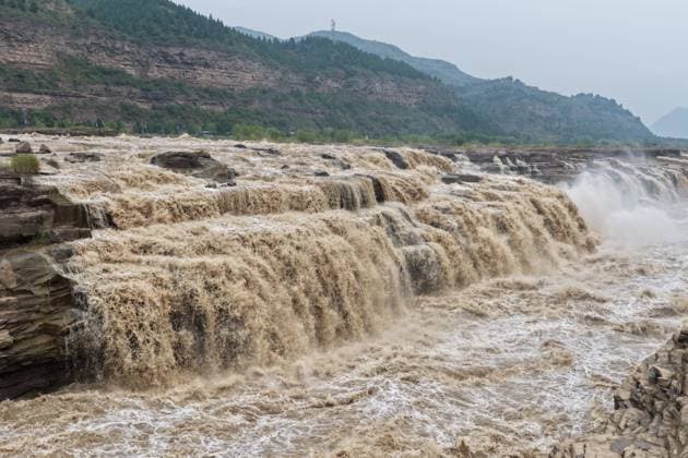YAN AN, CHINA - SEPTEMBER 20: Tourists visit the Hukou Waterfall on the Yellow River as water volume significantly increases due to sediment discharge and flood release from upstream reservoirs on September 20, 2026 in Yan an, Shaanxi Province of China. The main and side waterfalls have merged into a continuous line, creating a scenic view that has attracted large crowds.  Copyright: xVCGx 111668265446