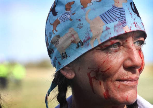 September 20, 2026, Huntingdon, United Kingdom: An activist wears a dog bandana and is covered in fake blood during the demonstration. Animal activists protest outside MBR Acres at Camp Beagle to Commemorate 50 years of The Animal Liberation Front (ALF). They gathered outside puppy breeding facility, MBR Acres that breed dogs for the vivisection industry. The protest Camp Beagle has had a permanent presence outside MBR Acres for five years. They say are staying until MBR Acres shuts down and the puppies are re-homed. Huntingdon United Kingdom - ZUMAs197 20260920_aaa_s197_408 Copyright: xMartinxPopex