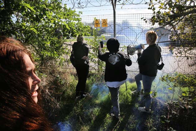 September 20, 2026, Huntingdon, United Kingdom: Activists gather down the side of MBR Acres with megaphones watched by security during the demonstration. Animal activists protest outside MBR Acres at Camp Beagle to Commemorate 50 years of The Animal Liberation Front (ALF). They gathered outside puppy breeding facility, MBR Acres that breed dogs for the vivisection industry. The protest Camp Beagle has had a permanent presence outside MBR Acres for five years. They say are staying until MBR Acres shuts down and the puppies are re-homed. Huntingdon United Kingdom - ZUMAs197 20260920_aaa_s197_416 Copyright: xMartinxPopex