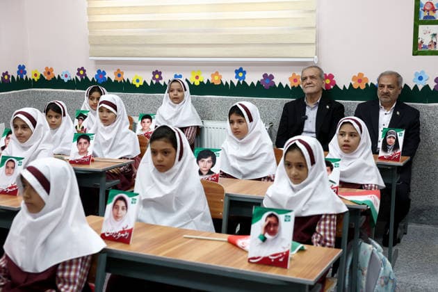 September 21, 2026, Tehran, Iran: Iranian President Masoud Pezeshkian and an official sit behind rows of first-grade pupils inside a classroom at Fatemeh Zahra Girls Primary School in Tehran, Iran, on September 21, 2026. The ceremony, known as Jashn-e Shokoufeha, or the Festival of Blossoms, marks the start of school for first-grade pupils across Iran. Iranian state media said about 1.154 million first-grade students were beginning school nationwide this year. Tehran Iran - ZUMAi98_ 20260921_zih_i98_004 Copyright: xIranianxPresidencyx