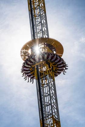 Oktoberfest 2026, the sun glints through the Hangover ride; the festival kicks off under bright sunshine and temperatures up to 24 degrees—perfect Oktoberfest weather. Opening day: September 19, 2026. Germany,