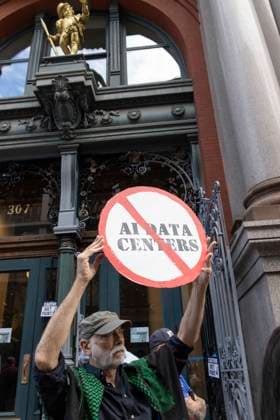 September 21, 2026: A coalition of climate organizations led by Climate Defenders hold an anti AI rally outside the offices of OpenAI in Lower Manhattan s Soho neighborhood at the start of Climate Week. An attendee holds a circle slash (no) AI DATA CENTERS sign. Demonstrators denounce OpenAIÃ¢â‚¬â ¢s massive data center buildout for causing higher utility bills, pollution, depleting water supplies and for worsening the climate crisis by creating a larger demand for fossil fuels. Protesters call for elected government officials to regulate Artificial Intelligence and pass data center moratoriums to protect communities and the planet from Big Tech. - ZUMAr174 20260921_znp_r174_020 Copyright: xGinaxMxRandazzox