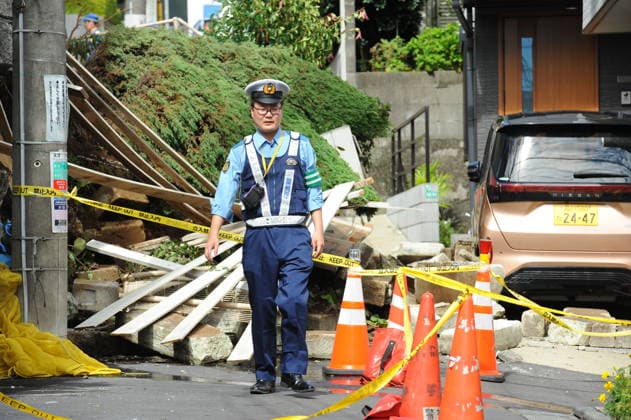 Typhoon Dujuan causes landslide damage in Tokyo TOKYO, JAPAN - SEPTEMBER 22 : A police officer stands at a restricted area where a residential retaining wall collapsed following heavy rain brought by Typhoon Dujuan in the Naka-Meguro area of Tokyo, Japan, September 22, 2026. Police barriers and tape were placed around the debris-covered street. David Mareuil Anadolu Tokyo Japan. Editorial use only. Please get in touch for any other usage.  Copyright: x2026xAnadoluxDavidxMareuilx